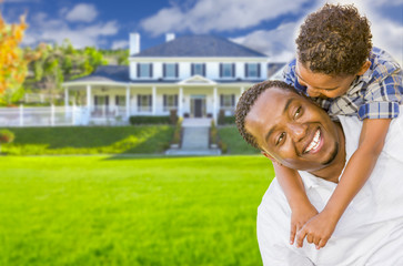 Mixed Race Father and Son In Front of House