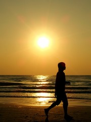 A man walk along the beach