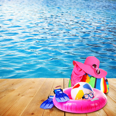 Bright beach accessories on sea background