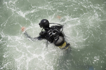 Commercial diver entering the water with a splash