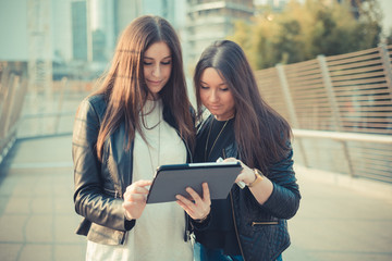 two young beautiful women friends in town