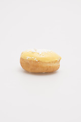Fresh baked single donut on a white background.