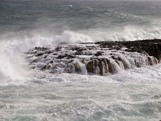 rock covered by the waves of the sea where ships can wrecked