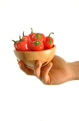 hand holding red peppers