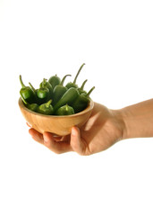 hand holding green peppers