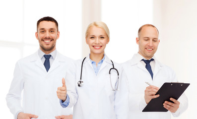 group of doctors showing thumbs up in clinic