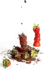 A group of fresh strawberries and dark chocolate with a white ba