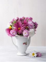 Still life with colourful chrysanthemums bunch on   wooden board