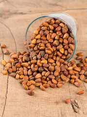 pine nuts on wooden surface