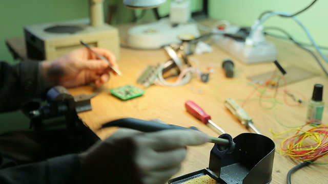 Scientist working soldering iron