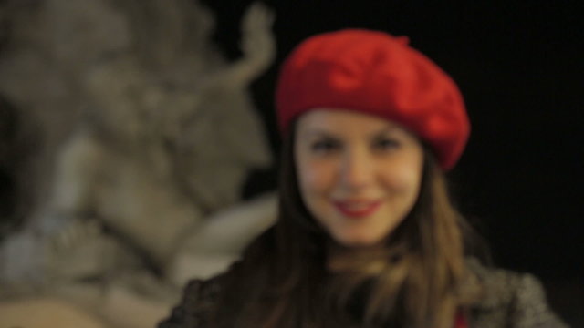 beautiful smiling young woman  -  fountain of gian lorenzo bernini in background