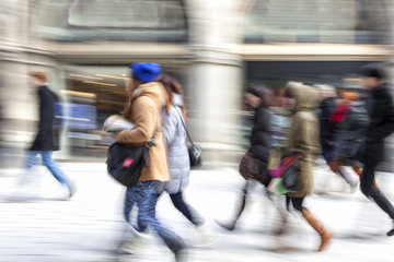 A shopper walking in front of shop window