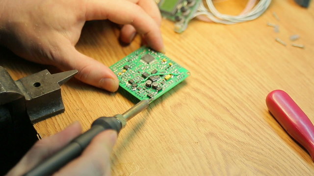 Scientist working soldering iron, close-up