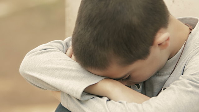 Close-up portrait of upset little boy