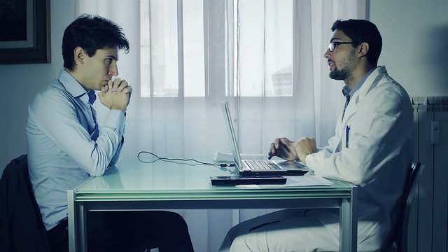 Doctor and patient discussing scan results in diagnostic center