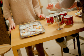 Mother's and son's hands going to the Christmas table