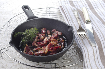 grilled bacon bits in a pan