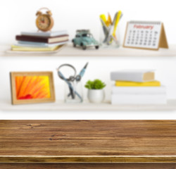 Wooden table on background of shelves with office objects