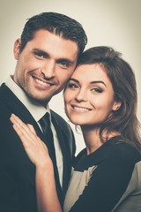 Happy smiling couple in suit and dress