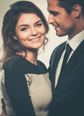 Happy smiling couple in suit and dress