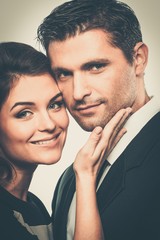 Beautiful cheerful young couple close-up isolated on white