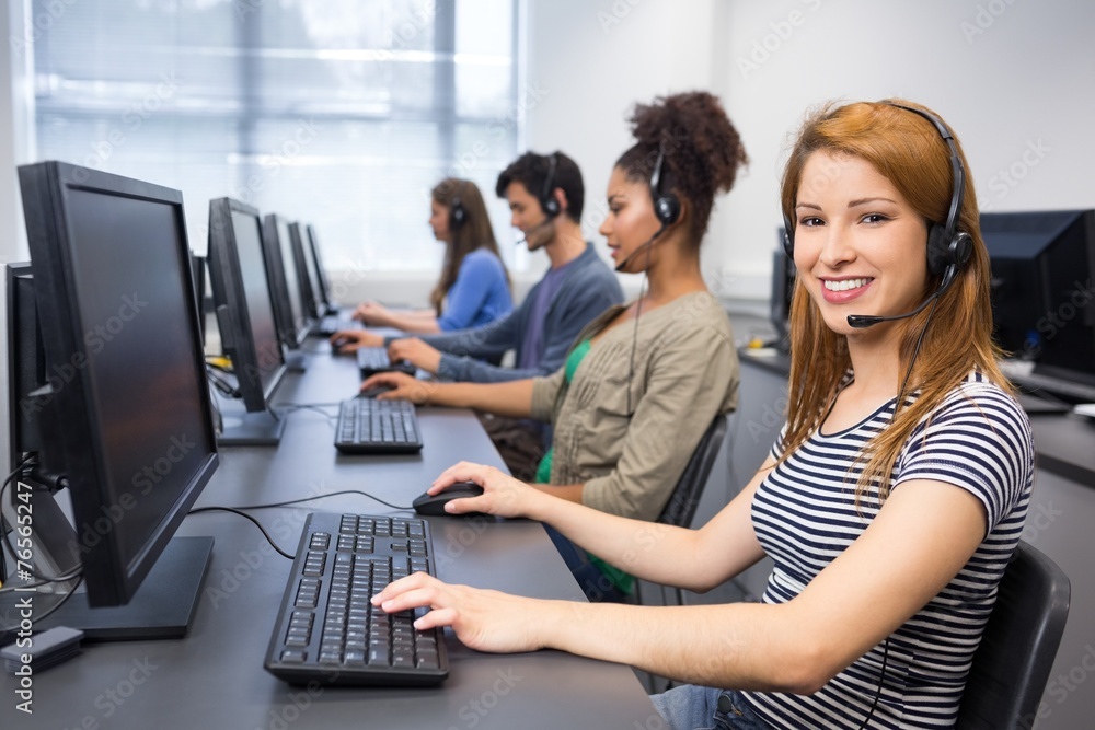 Poster Student smiling at camera in computer class