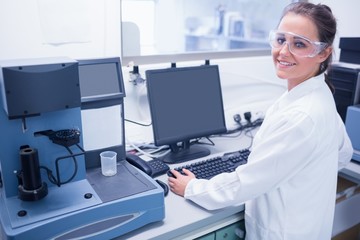 Portrait of a smiling young scientist with safety glasses