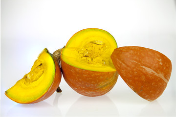 Cut a piece of ripe pumpkin on a white background