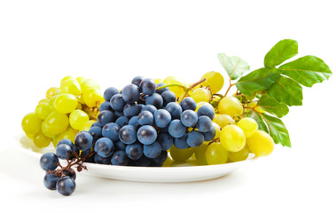 blue and yellow grapes with leaf on white background