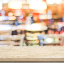 Empty wood table and blurred cafe with bokeh light background