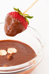 beautiful delicious strawberry with chocolate and nuts on stick