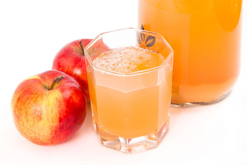 Jug of freshly squeezed apple juice, glass and two apples