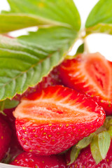 fresh cut strawberry with leaf macro isolated on white