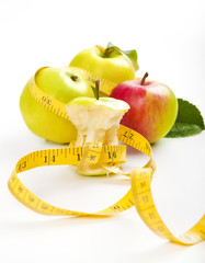 apple core and measuring tape. Diet concept
