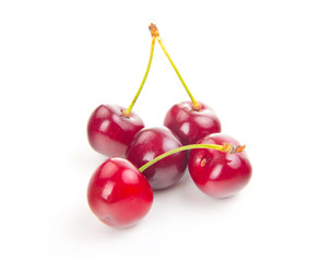 two isolated red cherries