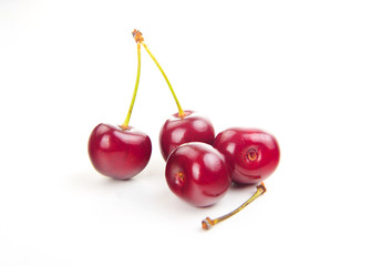 two isolated red cherries