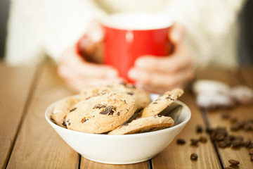Cookies and woman holding a cup
