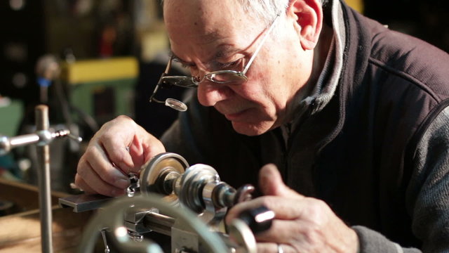 watchmaker working with a antique lathe