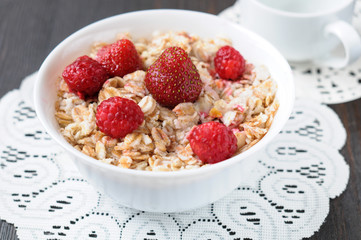 Cereal with strawberries and raspberries for breakfast