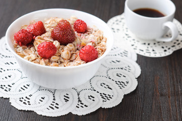 Cereal with strawberries and raspberries for breakfast