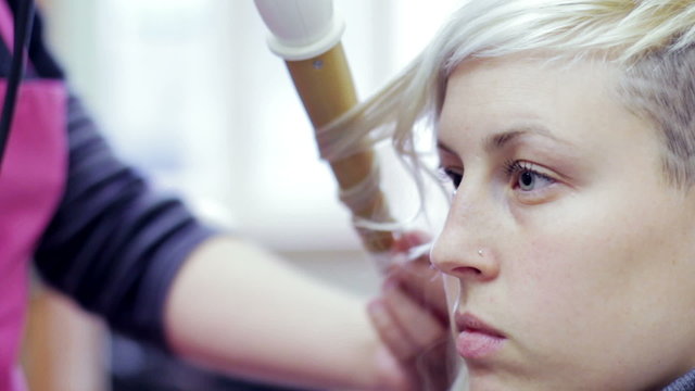 A hairdresser does a modern coiffure - hairdresser - hairstylist