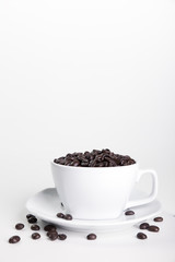 Coffee cup and beans on a white background.