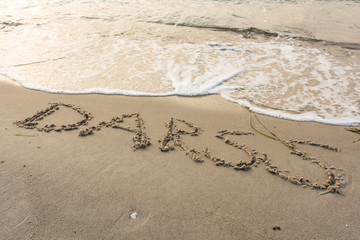 Schriftzug am Strand