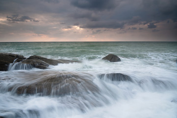 sea waves lash line impact rock on the beach