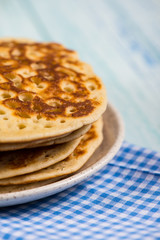 stack of pancakes on rustic wooden table