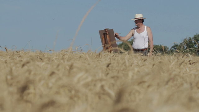 painter in the middle of a cornfield paints a beautiful landscape, canvas, easel