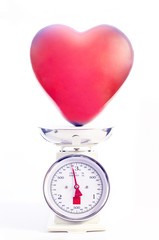 Red heart balloon is weighted. Concept love and health