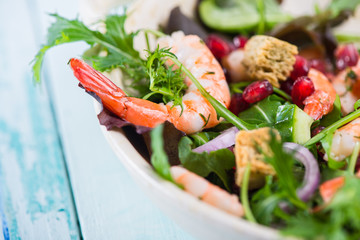 Fresh salad with prawns and pomegranade seeds