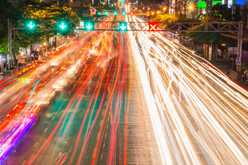 light streams from ongoing traffic in business district road