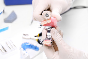Protetyk szlifuje protezę zębową